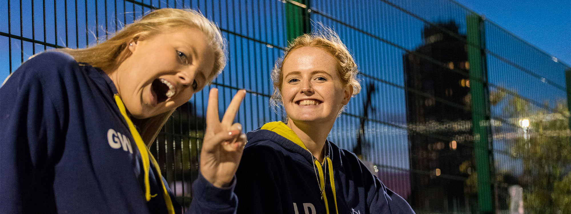 Two students smiling at the camera